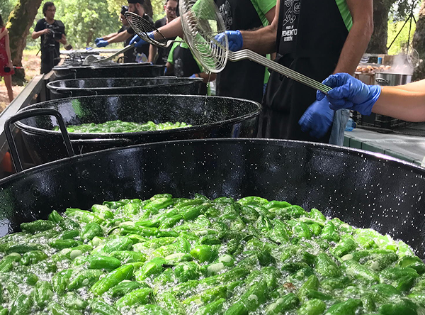 Traditional cooking of green peppers outdoors